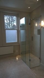 A wetroom shower area with shwoer screen and recessed shower valve