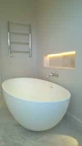 A free standing bath with a wall mounted bath filler tap