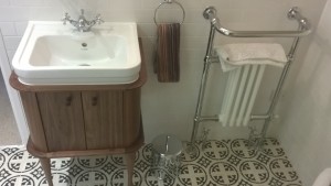 An oak basin unit with patterned floor tiles