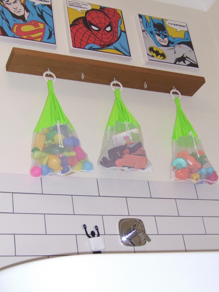 Picture of bath toys stored in nets abouve the bath