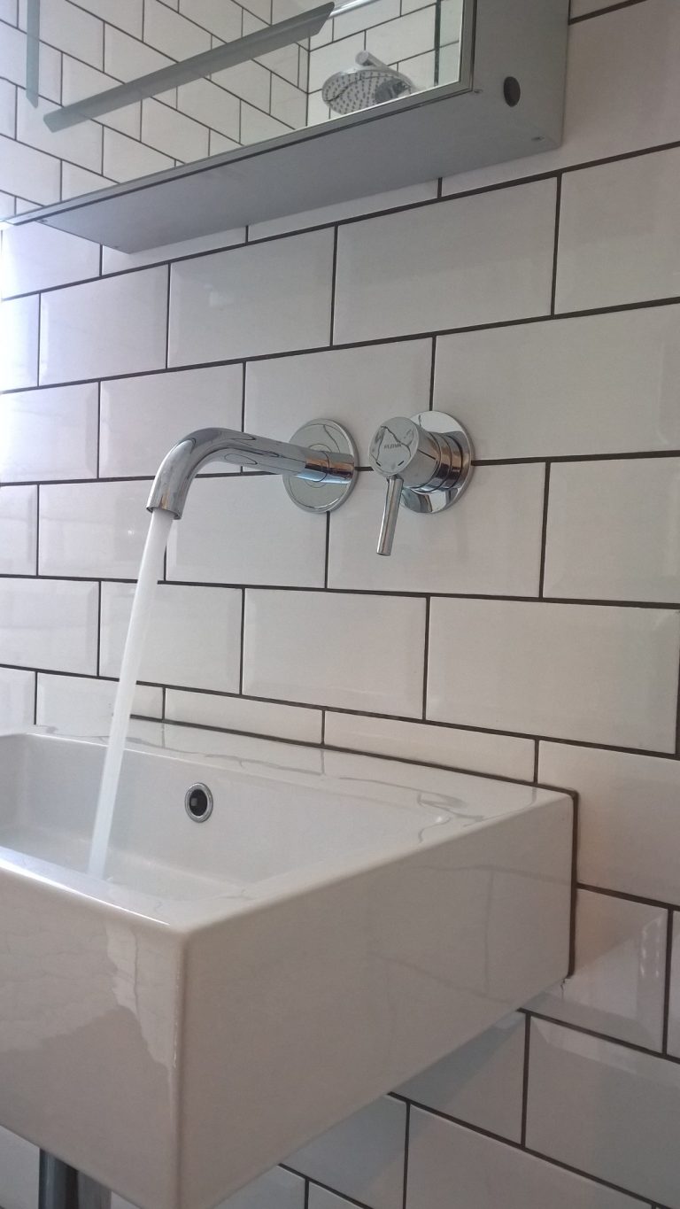 Wall mounted basin mixer tap