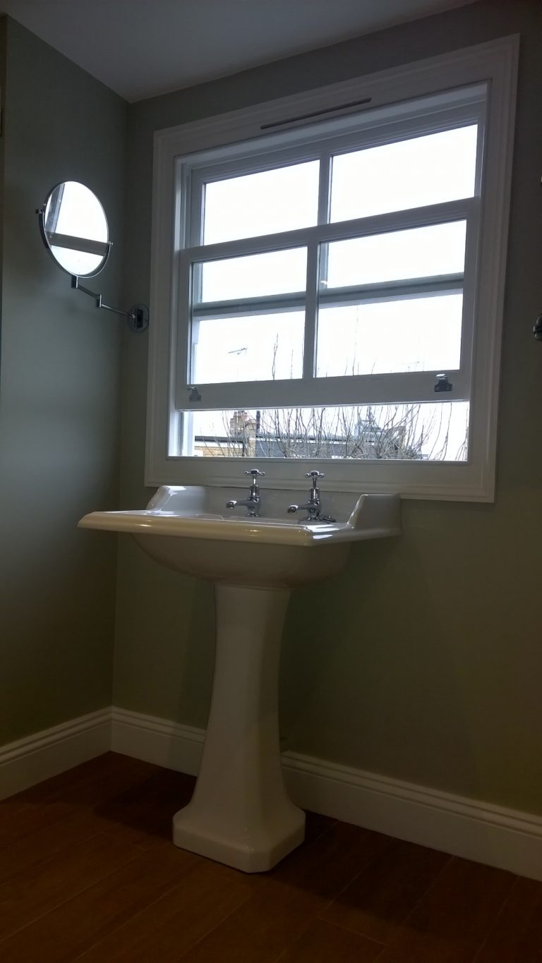 Basin under a window with a pull out mirror