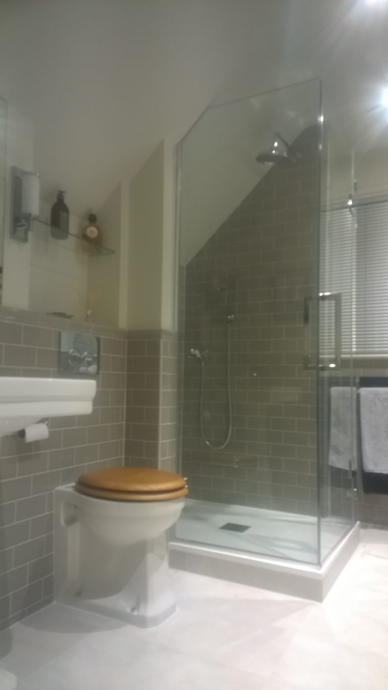 Loft shower room with a bespoke shower cubicle